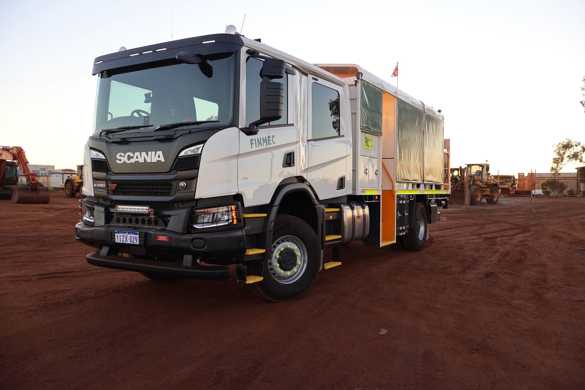 Finmec Scania service truck parked on a red-dirt mining site.