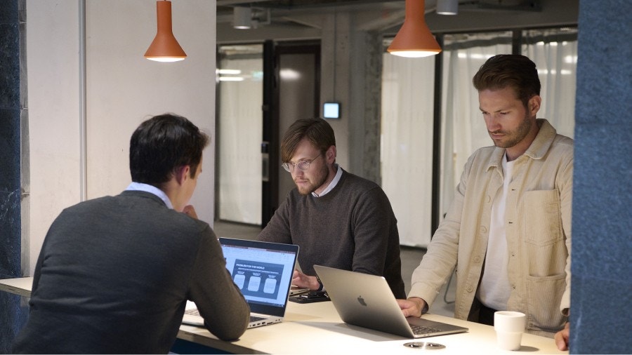 Three Scania employees working on their computers