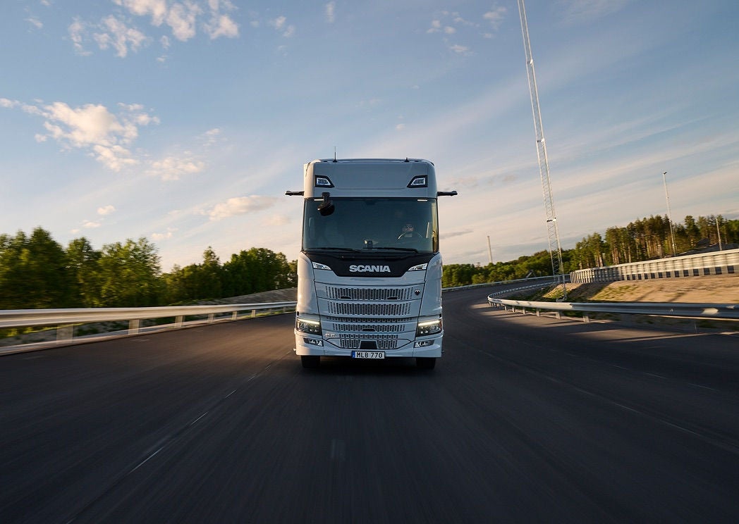 Front view of a Scania Dynamic R-series tractor unit travelling on a highway.
