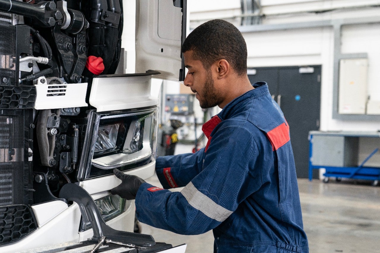 Technician working on a truck in workshop