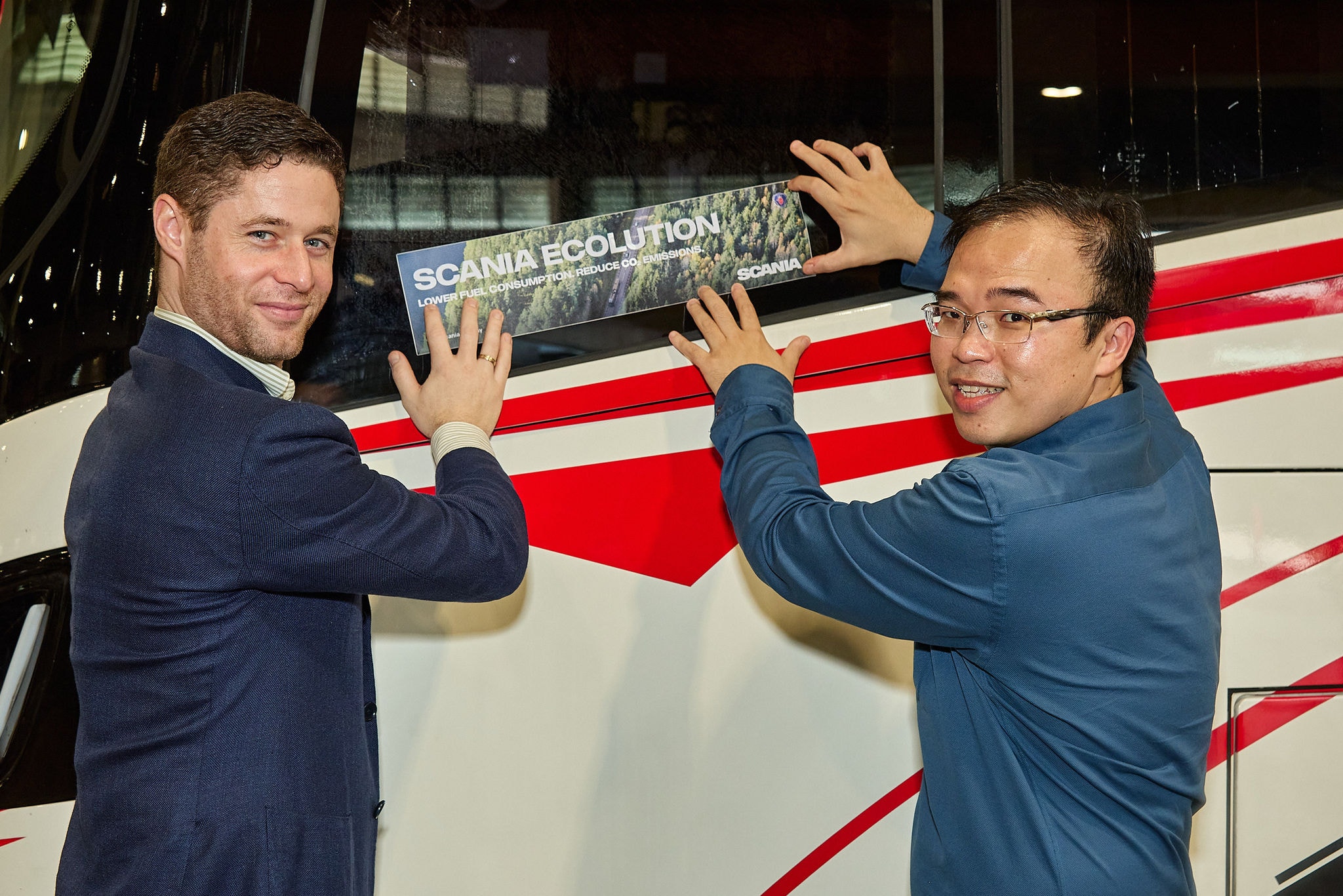 Sticking Ecolution sticker on bus with customer