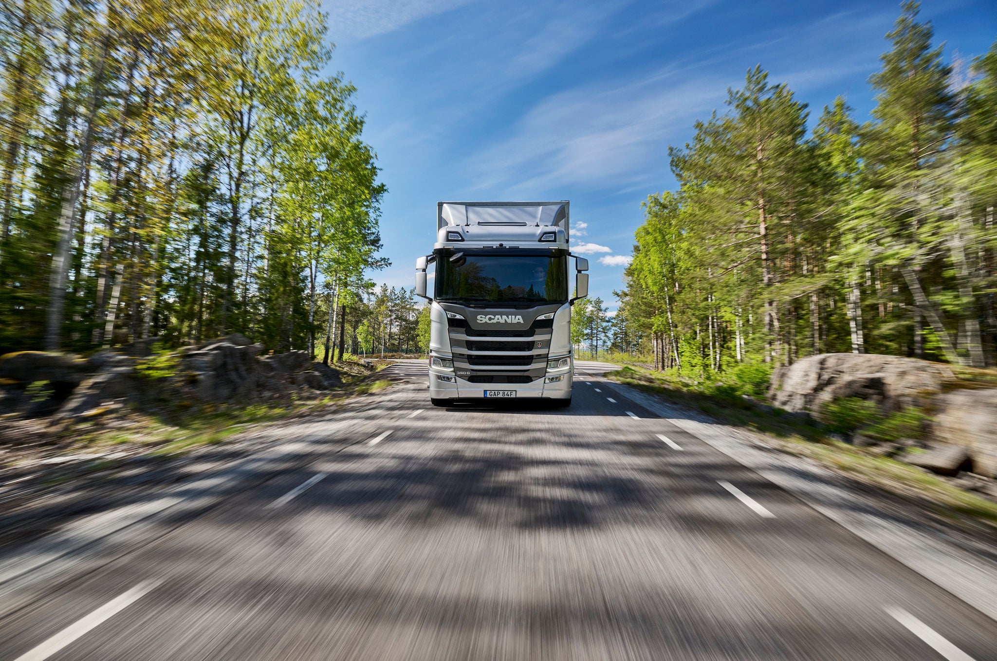 Front view of a silver semi-truck on a road.