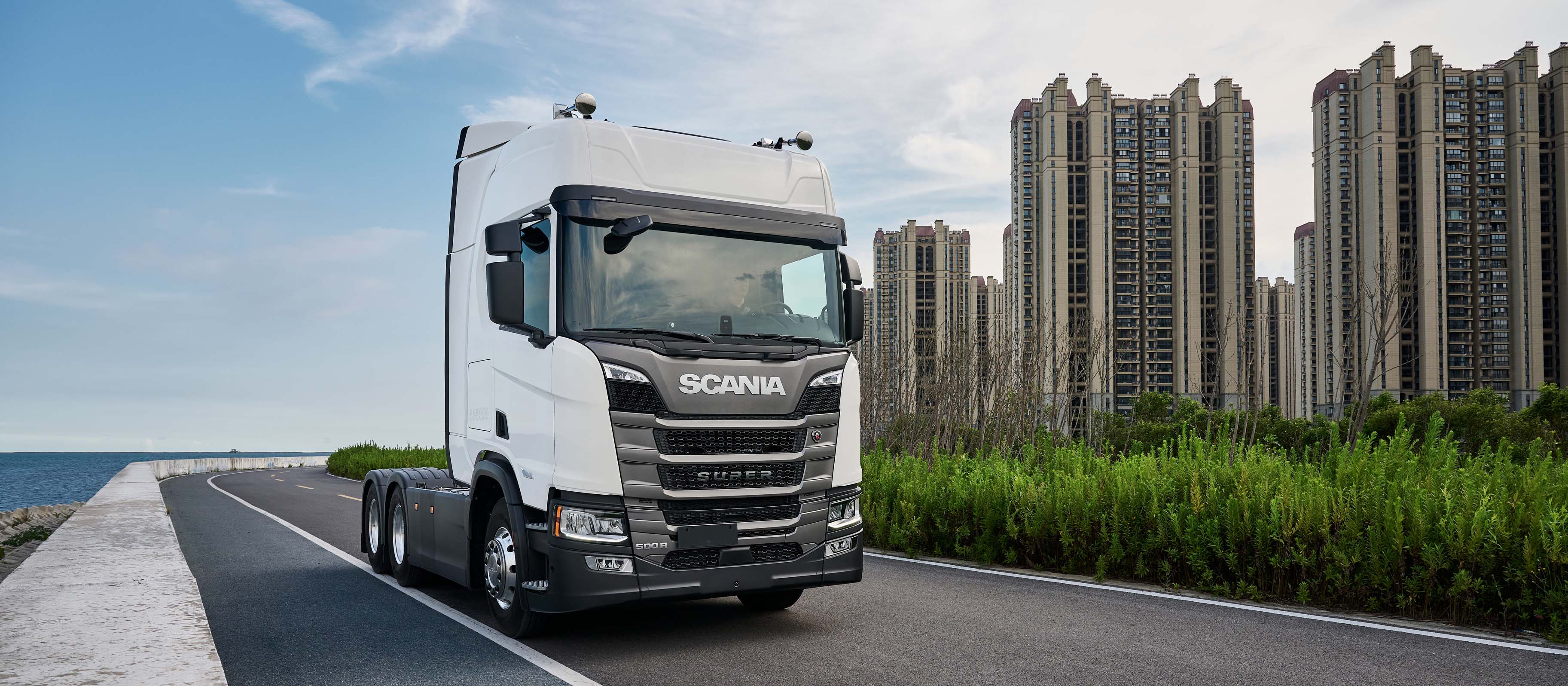 A Scania truck on a road by the sea in China