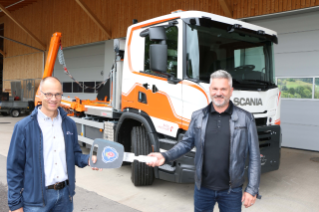 Bruno Christ (Scania Schweiz AG Pratteln / li.) übergibt den Fahrzeugschlüssel an Beat Tschudin.
