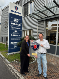 Le chef d'exploitation Services Andi Ryffel reçoit des mains d'Evelyne Wacker, direc-trice People & Culture de Scania Suisse SA, à gauche, la plaque d'anniversaire pour les 40 ans de partenariat avec Scania.
