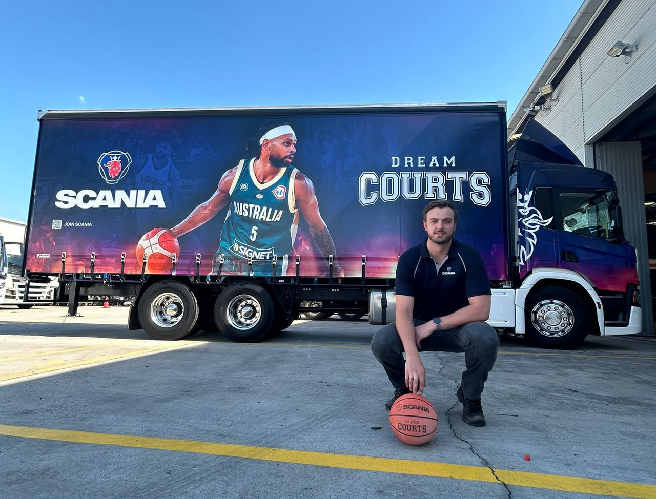 Man with basketball in front of truck