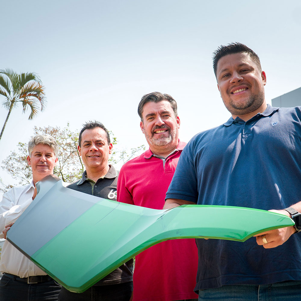 Scania employees at Scania's plant in São Bernardo do Campo, Brazil, holding a truck grille.