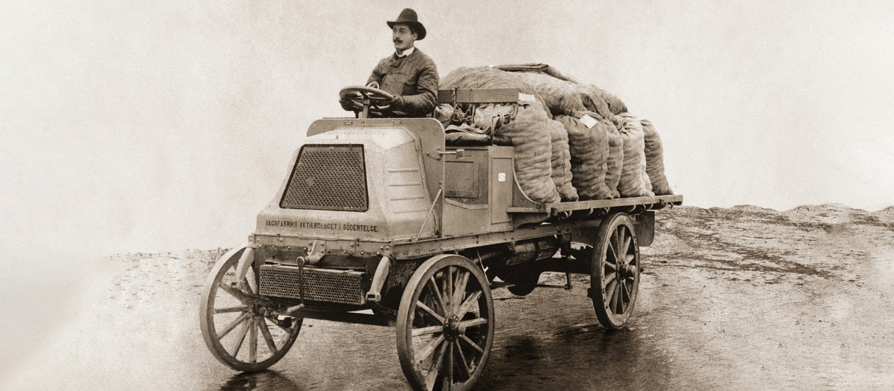 Man driving a very old truck