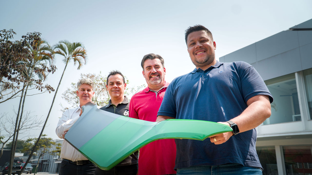 Scania employees at Scania's plant in São Bernardo do Campo, Brazil, holding a truck grille.