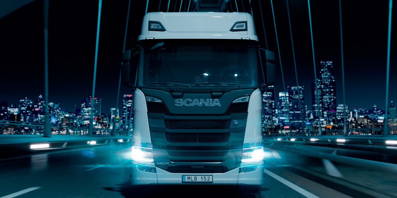 A Scania truck on the road at night