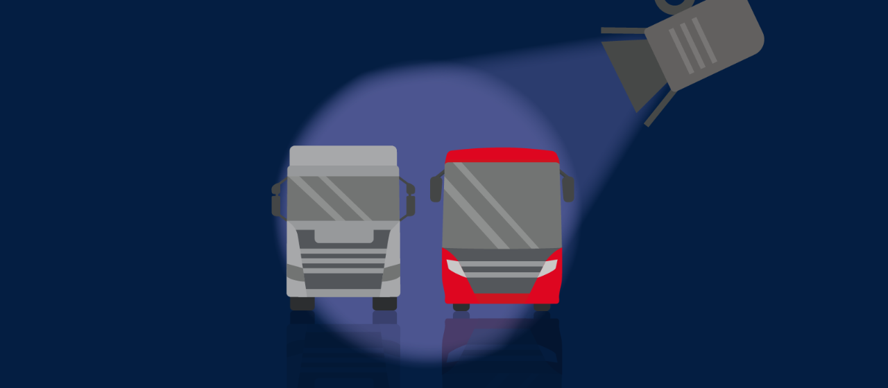 Spotlight shining on a truck and coach