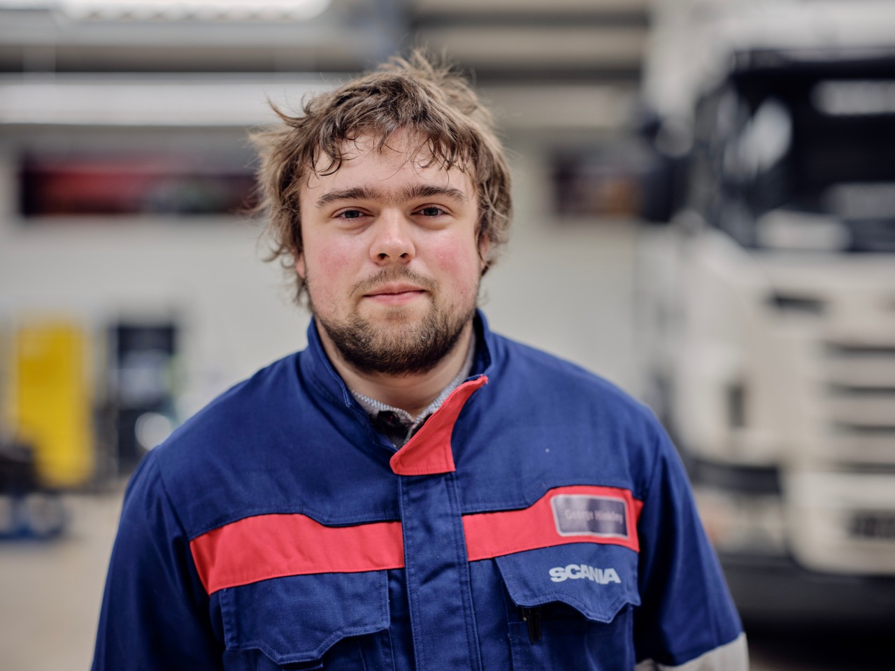 Apprentice of the Year, Geroge standing in Scania workshop