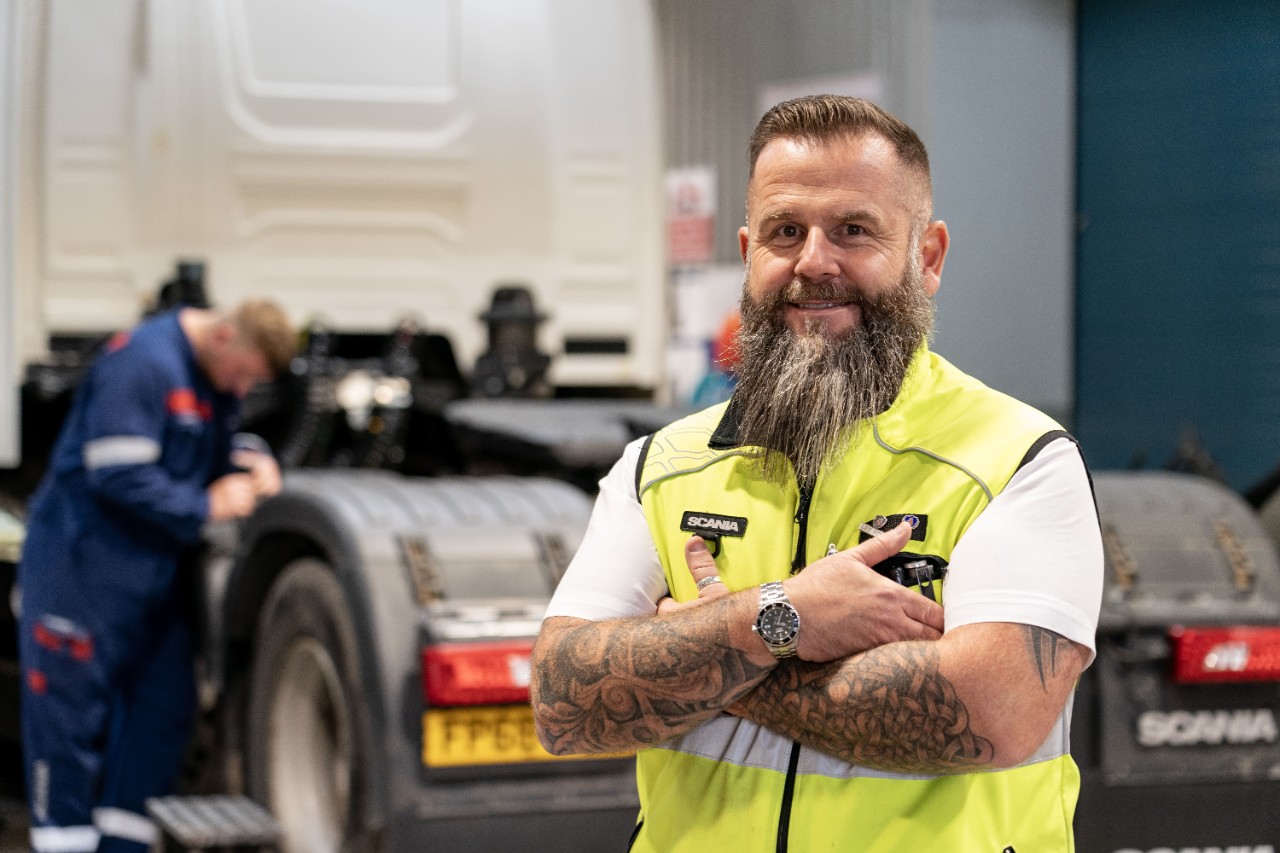 Scania colleauge standing in high-viz