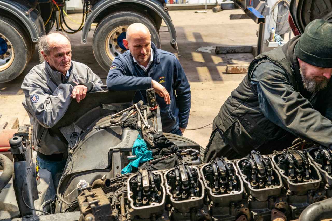 Field Technician Craig Moore looking at item in Scania workshop