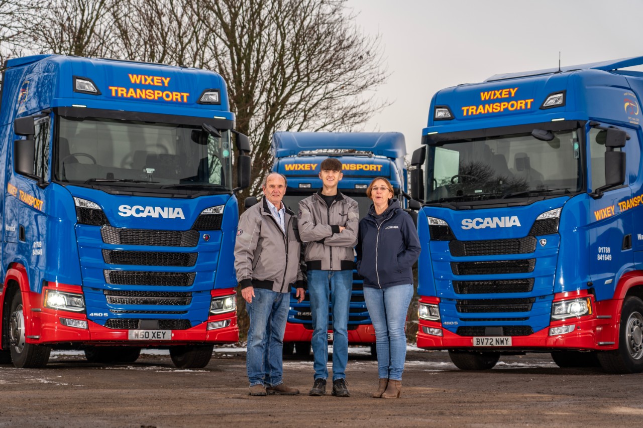 Field Technician Craig Moore standing outside in front of Scania sign