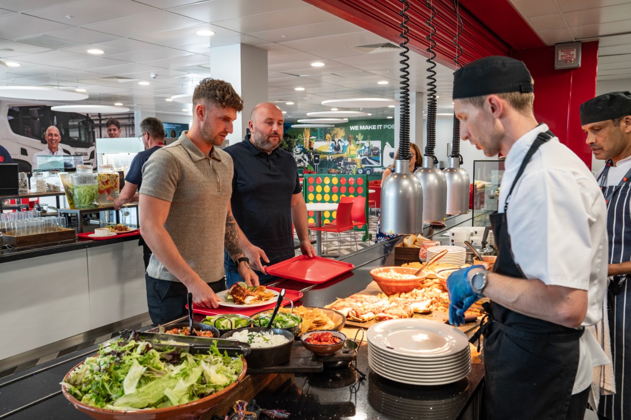 Scania colleagues standing in restaurant