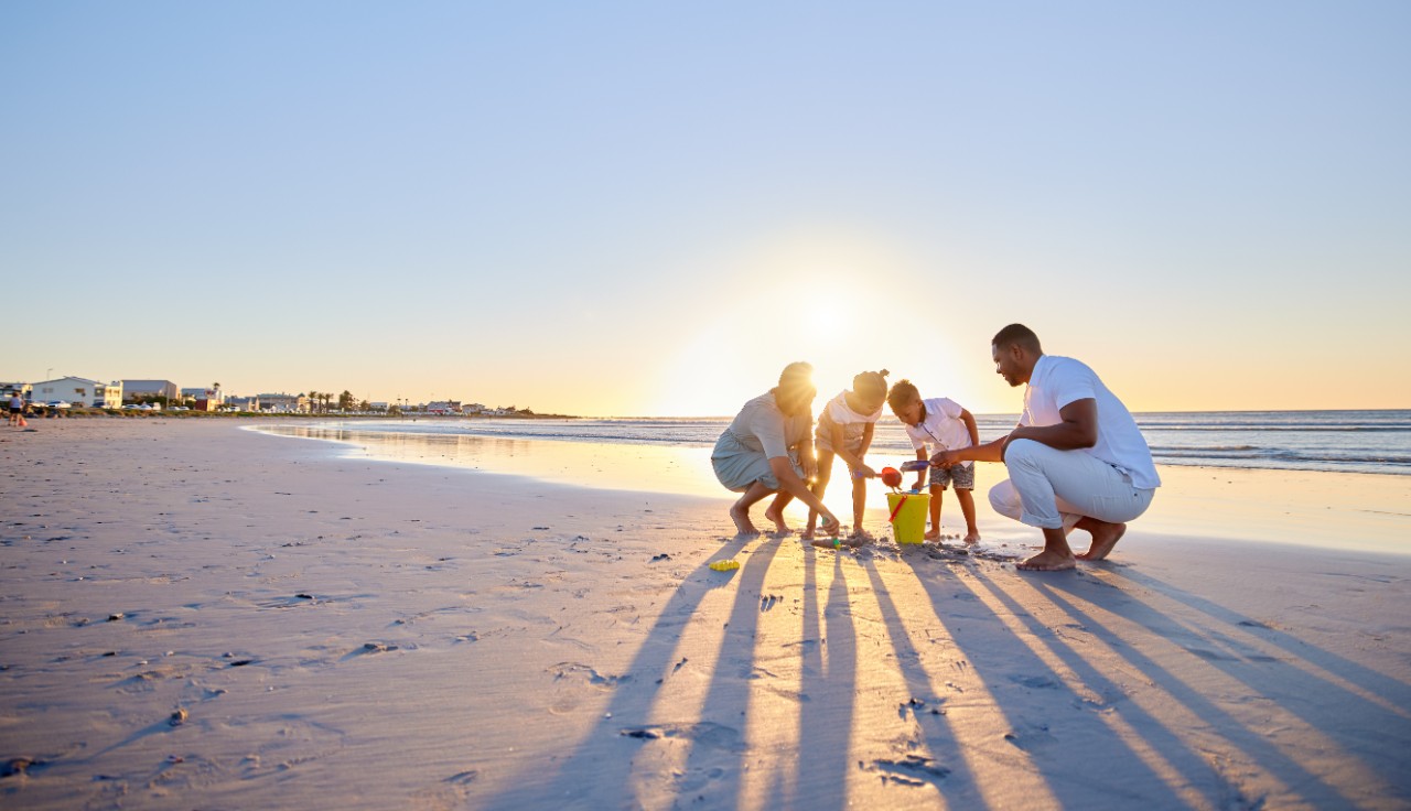 Family standing on beach