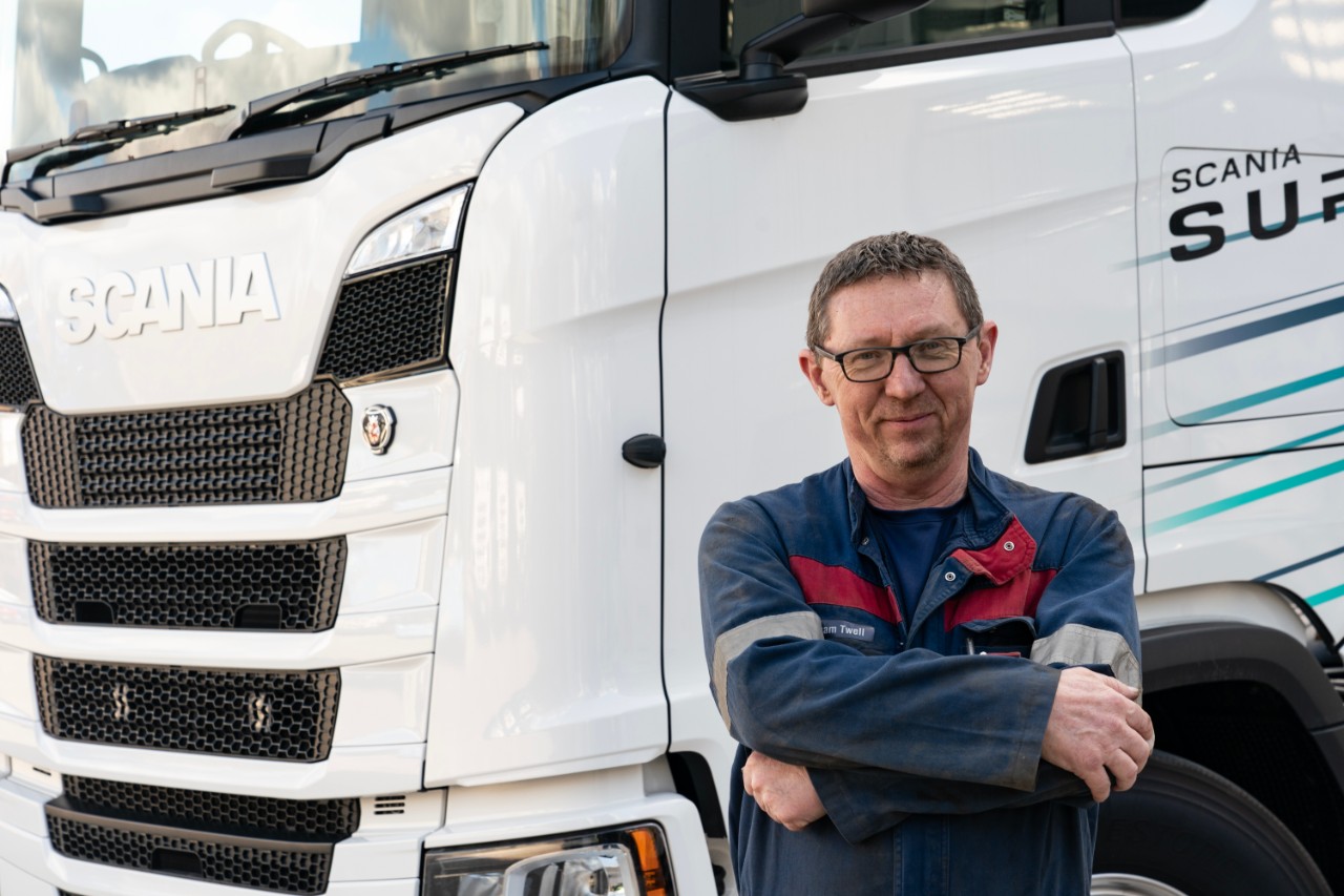 Scania technician standing in front of truck