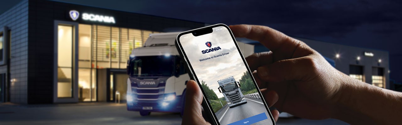 User holding phone with Scania Driver app on screen
