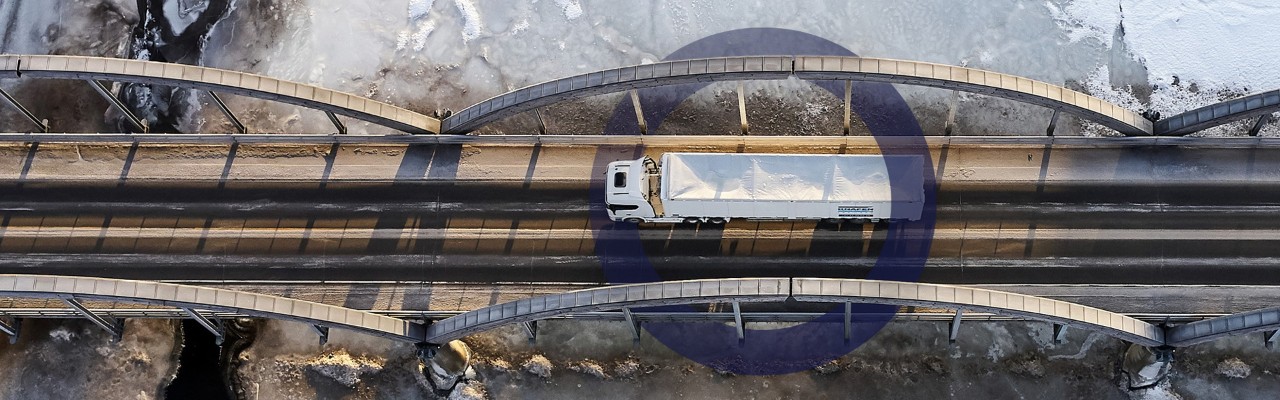 Birdseye view of truck driving on a bridge 