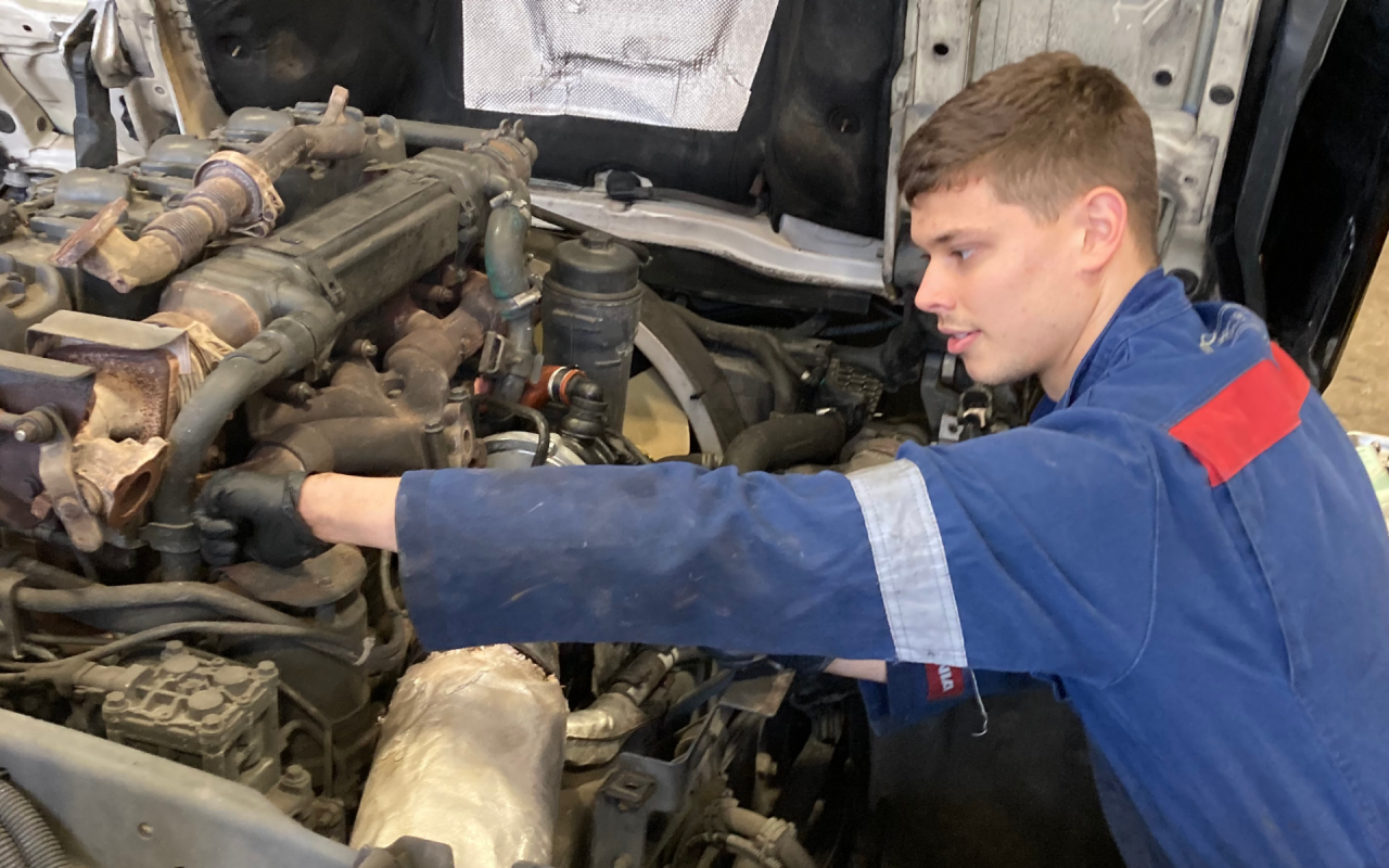 Apprentice working on engine