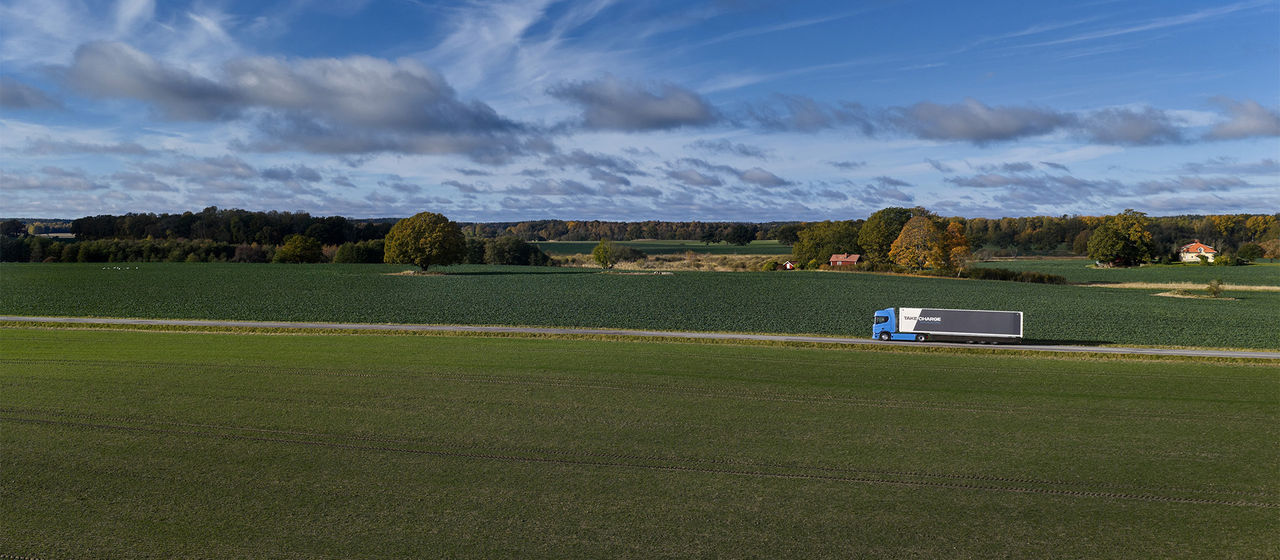 Scania truck driving along a narrow road