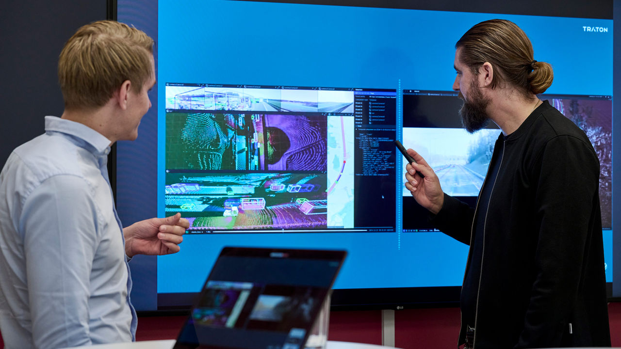 Daniel Frylmark and his colleague review visualised sensor data on a large screen during autonomous vehicle development.