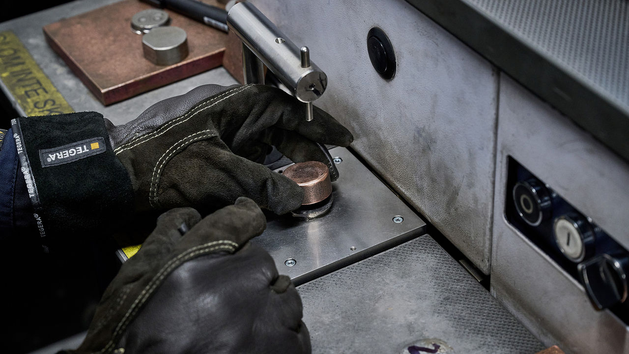 A Scania employee tests a casting's quality by extracting a small sample.